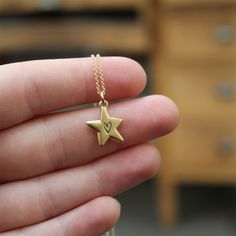 This little star is just the cutest. It has a heart in its center, on both sides!Cast in solid sterling silver and dipped in gold, it hangs from a gold filled chain. Choose your length from the drop down menu.The charm is 5/8" tall and 1/2" wide. Jewelry is shipped in a gift box without a receipt. I ship USPS First Class, shipping upgrades available at checkout. Star Charm Initial Pendant Necklace As Gift, Star Of David Charm Jewelry Gift, Personalized Sterling Silver Star Charm Necklace, Starfish Charm Pendant Necklace For Gift, Starfish Charm Pendant Necklace Gift, Initial Pendant Jewelry With Star Charm As A Gift, Initial Pendant Jewelry With Star Charm, Gift Starfish Charm Pendant Necklace, Dainty Star-shaped Charms Jewelry