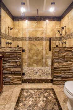 a bathroom with stone walls and flooring in the shower area, along with a toilet