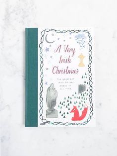 a very irish christmas book on a marble surface with a red fox and green border