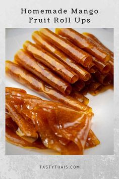 homemade mango fruit roll ups on a plate with text overlay that reads homemade mango fruit roll ups