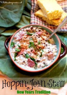 a bowl of soup with meat and vegetables in it on a table next to bread