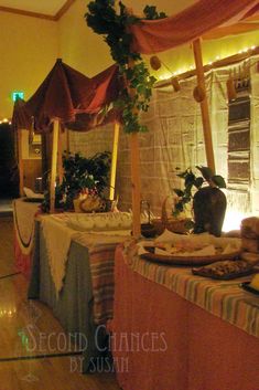 an image of a table with food on it in the middle of a room filled with curtains