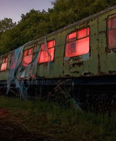 an old train car sitting in the grass