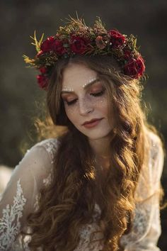 a woman with long red hair wearing a flower crown on her head and white dress