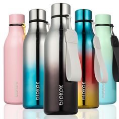 thermos bottles are lined up next to each other on a reflective surface,