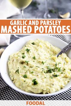 garlic and parsley mashed potatoes in a white bowl with a glass of wine