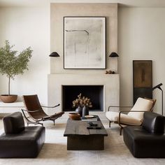 a living room filled with furniture and a fire place in the middle of a room