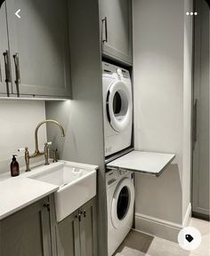 a washer and dryer are in the corner of this small laundry room,