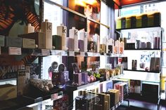 the shelves are filled with different types of perfumes