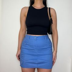 "Reworked skirt made from PreLoved cargo trousers, dusty blue colour with front and back pockets with button closure.  Colour: Light Blue Style: Cargo Skirt Size: Best fits UK 12 (US 8)* Measurements: Waistband - 15\" Length - 15\"   Model: Size Top UK 8/10 (US 4/6) Bottoms UK 10/12 (US 6/8) Height 5ft5\"   *Please contact us if you would like this item to be altered to fit a smaller size." Y2k High Waist Cargo Skirt With Pockets, Fitted Blue Mini Cargo Skirt, Blue Y2k Skort With Pockets, Blue High Waist Cotton Cargo Skirt, Y2k Style Fitted Cargo Skirt With Pockets, Y2k Blue Skirt With Pockets, Blue Utility Cargo Skirt With Pockets, Fitted Blue Utility Bottoms, Casual Blue Cotton Cargo Skirt