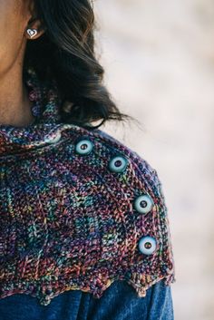 a woman wearing a sweater with buttons on it