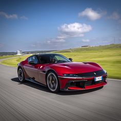 a red sports car driving down the road