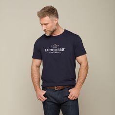 The Men's Lucchese Classic Embroidered Tee is a staple piece in our men's shirting collection. Under a vest or jacket, this embroidered tee is perfect for a day around the house or cheering on your team at the big game. Model is 6'1 and wearing size M. Classic Cotton Top With Embroidered Graphics, Classic Embroidered Cotton Tops, Handcrafted Boots, Handmade Boot, Embroidered Tee, Big Game, Staple Pieces, Mens Tees, The Man