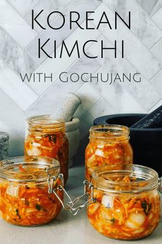 three jars filled with food sitting on top of a counter