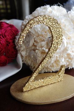 a close up of a gold sequin headband on a table next to yarn