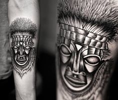 two men's tattoos with faces on their arms, one in black and white