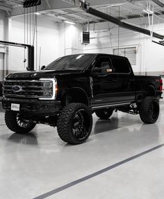 a large black truck parked in a garage