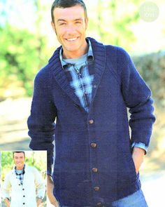 a man wearing a blue cardigan and smiling at the camera with his hands in his pockets