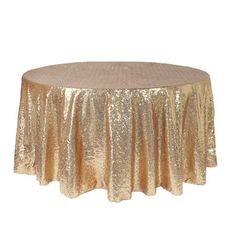 a gold sequinized tablecloth on a round table with a circular skirt in the center