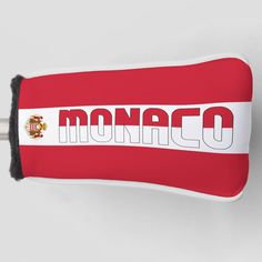 a red and white stuffed animal with the word monaco on it's back side