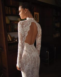 a woman in a white wedding dress looking back