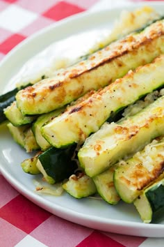 grilled zucchini on a white plate with parmesan cheese