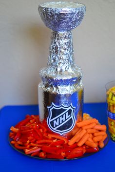 a hockey trophy sitting on top of a blue table next to carrots and candy