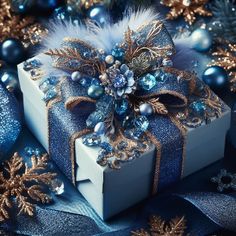 a blue and white present box surrounded by christmas decorations