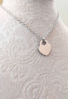 Handmade simple dainty necklace, made with small silver stainless steel heart pendant and dainty stainless steel cable chain. Stainless steel lobster claw closure. Stainless steel heart pendant size: ~15*17mm Stainless steel cable chain width : ~2.4mm ---> Similar necklace design available on the below link:  https://www.etsy.com/listing/1141396049/silver-heart-necklace-or-bracelet-small?click_key=8cba0b570ede54fef1c5ac068ffc0d0549adbcfc%3A1141396049&click_sum=dadddf07&ref=shop_home_active_27&cl Dainty Stainless Steel Heart Necklaces, Dainty Nickel-free Silver Heart Necklace, Dainty Heart-shaped Necklace For Gift, Minimalist Heart-shaped Metal Charm Necklace, Dainty Heart-shaped Stainless Steel Necklaces, Simple Heart Necklace, Small Heart Necklace, Necklace Everyday, Toggle Necklace