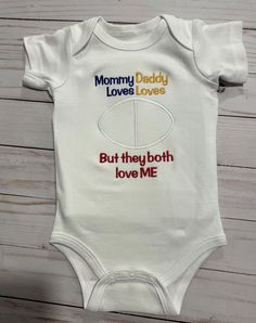 House Divided baby Embroidered bodysuit or shirt!  This little bodysuit or shirt is embroidered on.  Not only is it a super cute way to support mommy and daddy's teams but the embroidery makes it more durable wash after wash!  Also makes a great keepsake.   This  cute little top for your baby or toddler can be customized to any team, colors... etc. Top will look like sample above but with the logos of the teams you choose. Colors will be coordinating to each team. If you want specific colors, please specify this, I have no problem doing the colors you would like. Please do not forget to put the teams you would like in notes. I can't go off of the pictures because I do change them often. All items are made when ordered, in the order received. Please see shipping times for current production White Cotton Family Matching Onesie, Personalized Cotton Onesie For Gender Reveal, White Cotton Onesie For Gender Reveal, Customizable Cotton Bodysuit For Family Matching, Personalized Cotton Onesie For Playtime, Personalized Cotton Onesie, Personalized Cotton Playtime Onesie, Personalized Unisex Cotton Onesie, White Cotton Onesie For Parenting