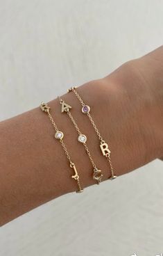 This beautiful bracelet features up to six 14K gold letters of your choice. Choose from several options for the accent stones! EXAMPLE SHOWN: Letter #1: R Stone #1: diamond Letter #2: J Stone #2: diamond Letter #3: J Available in 14K Yellow Gold, 14K White Gold or 14K Rose Gold Measures 6" + 1" extender Letter measures approx. 5mm Each letters measurement will vary slightly based on the letter FINAL SALE Letter Bracelets Gold, J Bracelet Letter, Cheap Birthday Charm Bracelet With Letter Beads, Diamond Letter Bracelet, Yellow Gold Cubic Zirconia Name Bracelet As Gift, Diamond Name Bracelet For Gift, Fine Jewelry, Fine Jewelry Diamond Name Bracelet For Gift, Fine Jewelry Diamond Name Bracelet As Gift, 14k Gold Name Bracelet With Initials For Anniversary