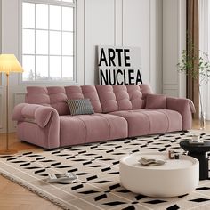 a living room filled with furniture and a large rug on top of a hard wood floor