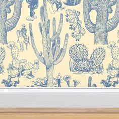 a blue and white cactus print wallpaper in a wooden frame on a yellow background