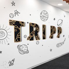 there is a wall with the word trip painted on it in black and gold letters