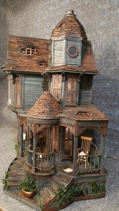 a doll house made out of wood on display