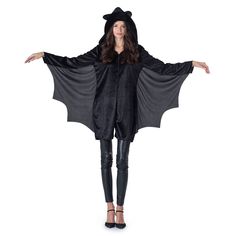 a woman wearing a bat costume with her arms spread out in front of the camera