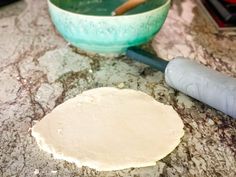 the dough is next to a rolling pin on the counter