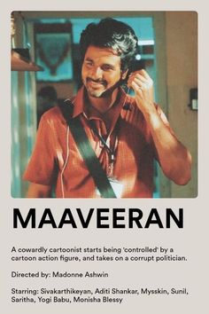 a man with headphones on talking on a cell phone in front of an advertisement for maaveran