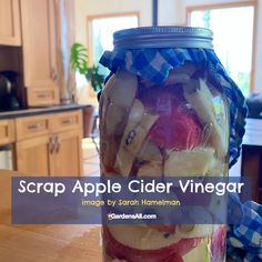 a jar filled with sliced up apples on top of a wooden table