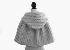 the back of a woman's sweater is shown in black and white