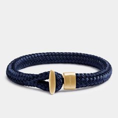 The Voyage Gold bracelet is made from hard-wearing marine nylon that will not fade over time. The pin closure is machined with precision from matte gold plated 316L stainless steel.Remarkably simple in deep navy blue, the Voyage Gold works perfectly as a minimalist statement or with one of our cuff bracelets.Available in four sizes. Also offered in matte silver color.Every bracelet comes protected in a soft velvet pouch, with a quality card, and presented in the original Elegatto gift box. Navy Bracelet, Rope Bracelet Men, Surf Gifts, Nautical Bracelet, Surfer Bracelets, Twisted Bracelet, Deep Navy Blue, Gold Armband, Simple Bracelets