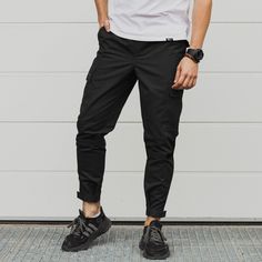 Cargo pants are a trend in recent years. They became so popular that they began to be used everywhere in the most different combinations of clothes. If you want to follow the trend, cargo pants will help you! GENERAL INFORMATION - Sizes: S, M, L, XL, XXL - Colors: black - Fabric: 100% cotton - Slim fit, velcro cuffs at the bottom - Velcro below the knee - Elastic band and cord for adjustment at the waist. Pockets: - main oblique in front - patch pockets in the knee area - overhead at the back SI Casual Cargo Pants For Urban Adventures, Casual Work Pants With Functional Pockets, Casual Pants With Pockets For Urban Adventures, Casual Pants With Pockets For Everyday, Casual Tapered Leg Pants With Functional Pockets, Casual Trousers With Functional Pockets, Casual Tapered Leg Bottoms With Functional Pockets, Cyberpunk Pants, Steampunk Pants