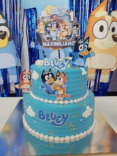 a blue cake with cartoon characters on it