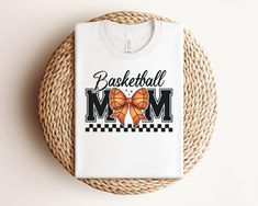 Show your team spirit with this Basketball Mom Graphic Tee! Perfect for passionate basketball moms, this shirt is both stylish and comfortable for game days or casual outings. Makes a great gift for any basketball-loving mom. Whether cheering from the sidelines or running errands, this tee is versatile and trendy. Available in various sizes. [GRAPHICS/TEXT] All graphics and/or texts are produced using high-quality printing inks and techniques; No glitter or heat transfer vinyl is used unless specified in description. [HOW TO ORDER] 1- Please review all of our images/video (you will receive the design as it is displayed in the images, including color(s). Designs are applied to the front of the garment, unless specified.) 2- Select product color and size from the drop-down menu 3- Click add Basketball Mom Shirt Ideas Glitter, Basketball Mom Shirt Ideas, Mom Shirt Ideas, Basketball Mom Shirts, Mom Graphic Tees, Trendy Mom, Basketball Mom, Transfer Vinyl, Mom Shirt