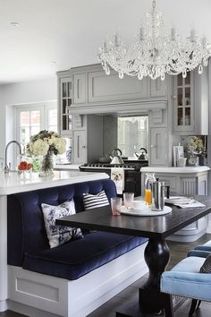 an elegant kitchen with blue and white furniture