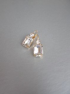 "These beautiful elegant earrings are made with fancy emerald cut and round Swarovski crystals. Available in gold, rose gold and silver finish. Matching necklaces an the bracelet are also available and they are shown in the last two photos. - 1 3/8\" long from the top of the ear wire to the bottom of the earring and 1/2\" wide - Leverback - For the matching bracelet please take a look here: https://www.etsy.com/listing/754440549/swarovski-crystal-bridal-bracelet-gold?ref=shop_home_active_19& Bridal Gold Earrings, Wedding Drop Earrings, Inexpensive Jewelry, Earrings Emerald, Crystal Bridal Earrings, Gold Bridal Earrings, Wedding Earrings Drop, Matching Jewelry