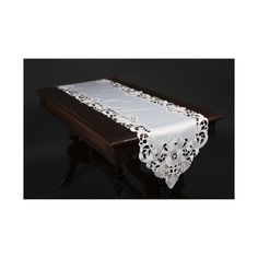 the table cloth is white and has lace on it, along with a red border