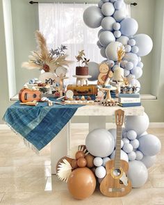 a table filled with balloons and other decorations