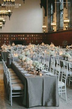 the tables are set up with candles and centerpieces for an elegant wedding reception