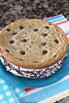 a chocolate chip ice cream sandwich on a blue plate with a checkered table cloth